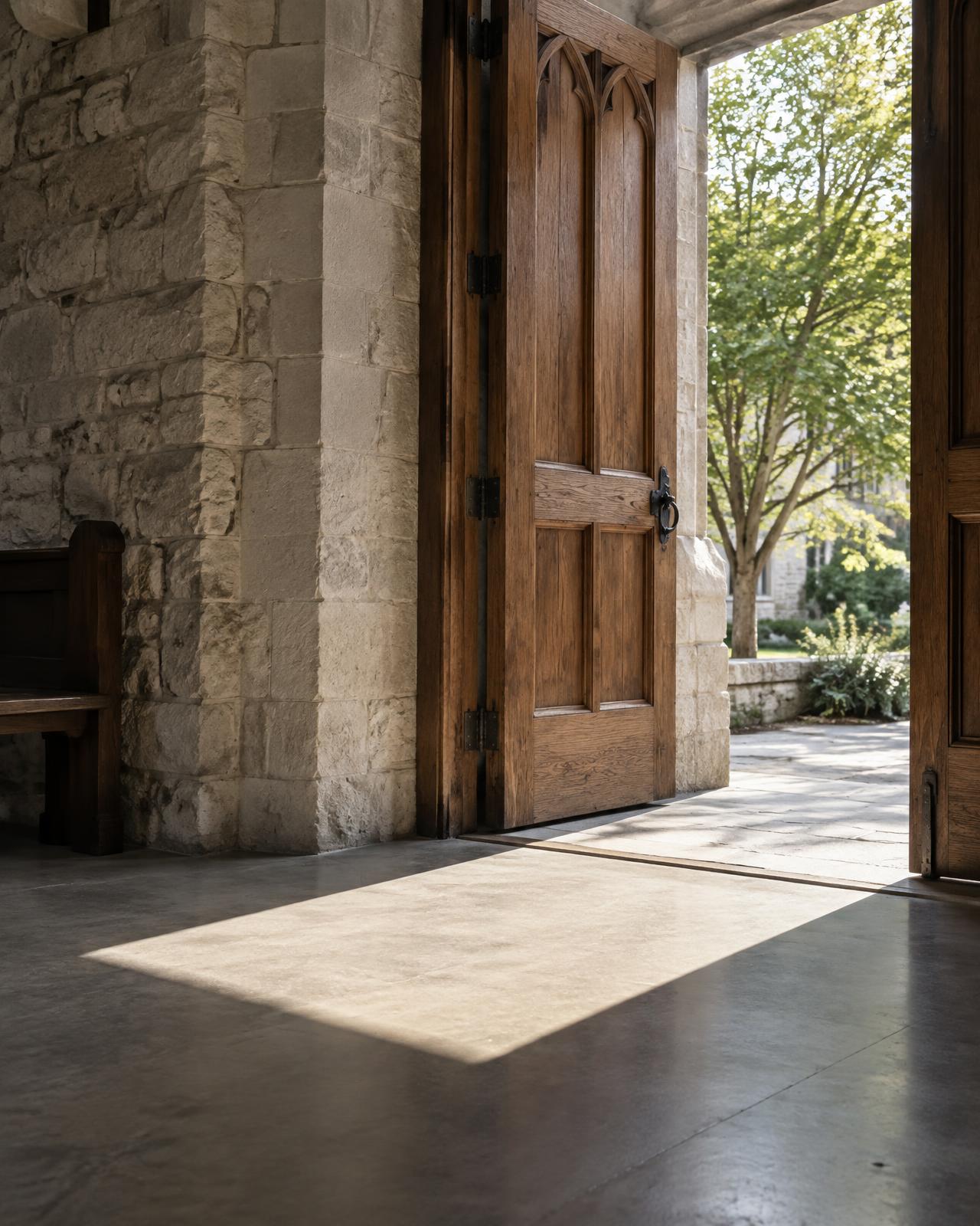 Illustrative open church doorway with sunlight crossing the threshold